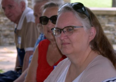 Photo of people sitting & watching the Auction 2023