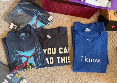 A variety of Mensa T-shirts 2025